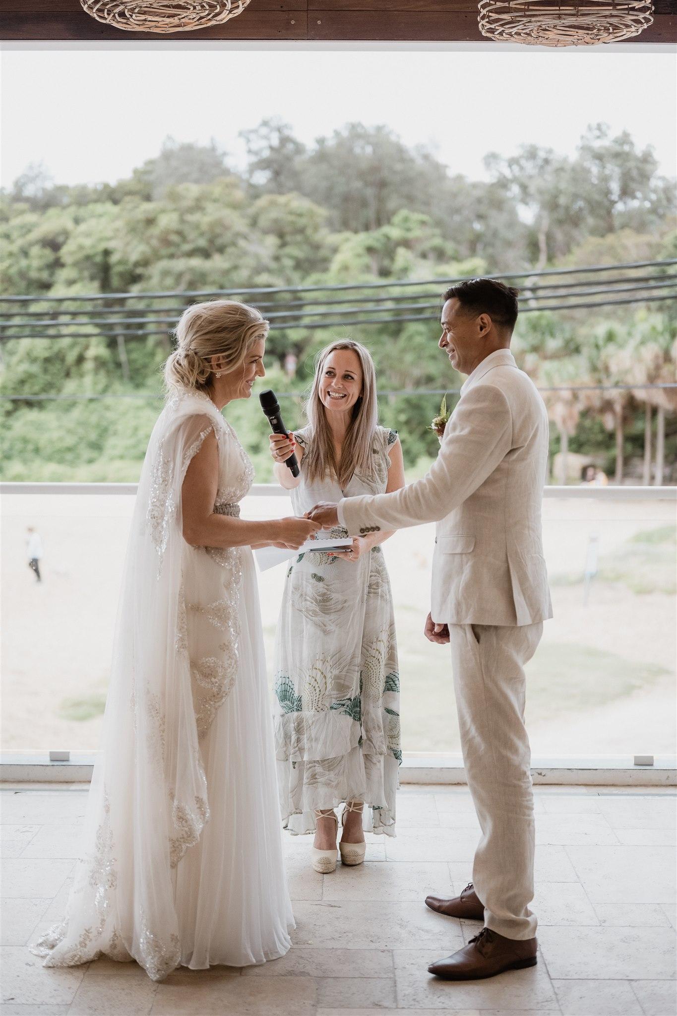 Sarah Emery at Shelly Beach Boathouse, in conversation with a couple before their ceremony.