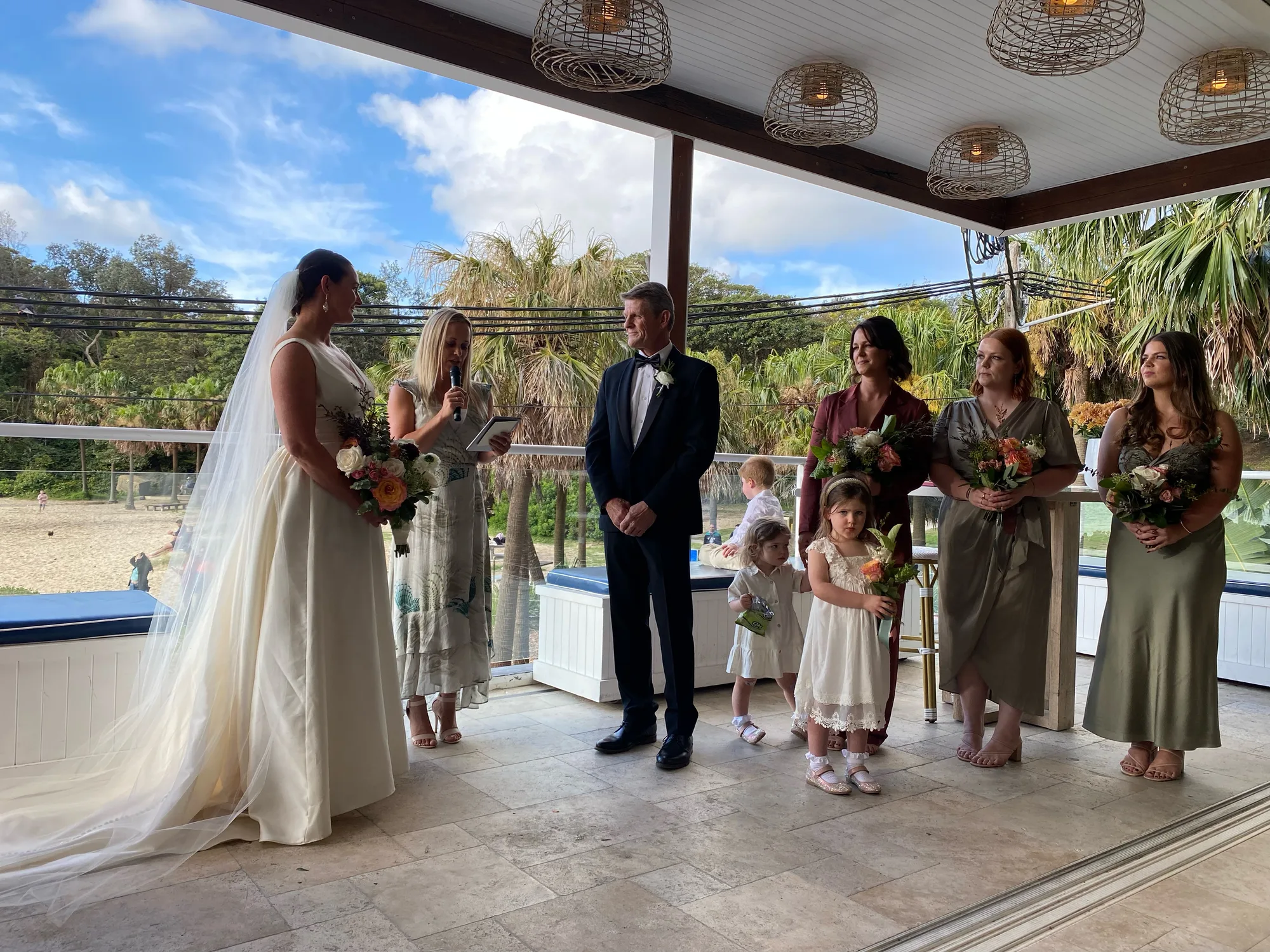 Couple exchanging vows by the water
